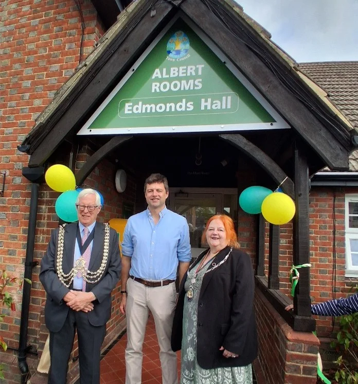 Reigate and Banstead Mayor Cllr Nick Harrison, Chris Coghlan MP and Horley Town Mayor Cllr Lynnette Easterbrook outside the Albert Rooms entrance, decorated with balloons, at the unveiling